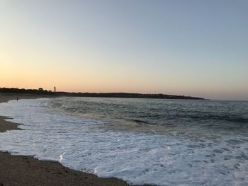 Scenic view of sea against clear sky during sunset