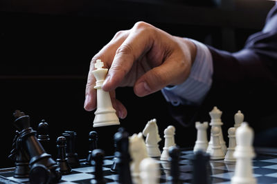 Cropped image of business man playing chess