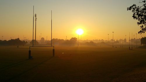 Scenic view of field against sky during sunrise