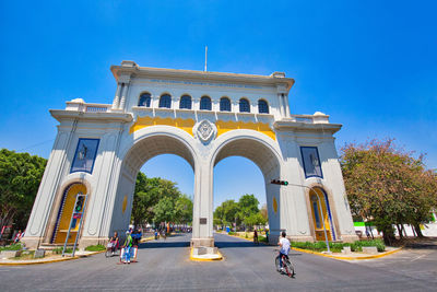 People walking in front of historical building