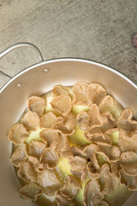 Directly above shot of potato chips in wok on table