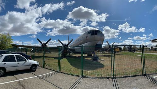 Airplane on runway against sky