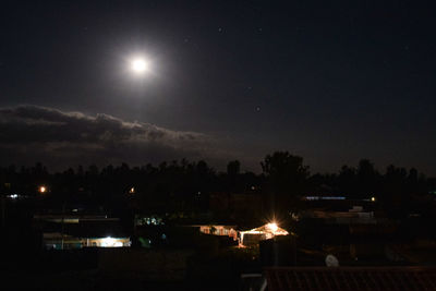 Scenic view of illuminated moon against sky at night