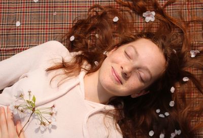 Smiling girl lying down on bed