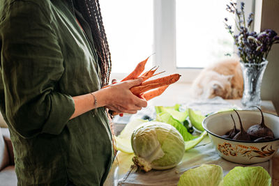 Faceless portrait of vegan woman holding vegetables. veganism, vegetarianism, plant-based diet