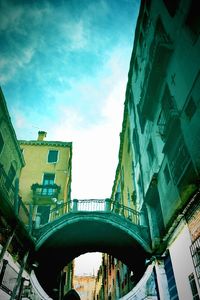 Low angle view of bridge against sky in city