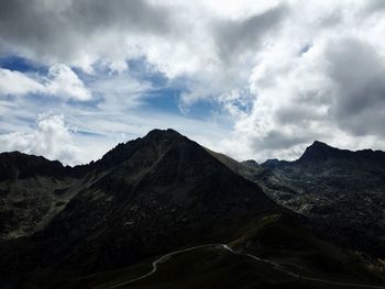 Scenic view of mountains against cloudy sky