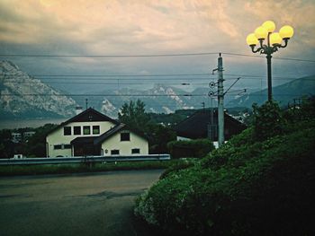 Street light against cloudy sky