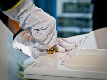 Cropped hand holding coffin at church