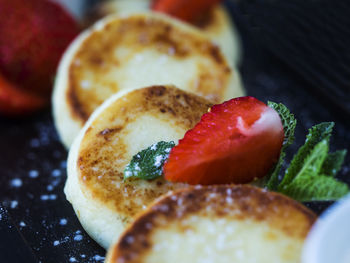 High angle view of cheesecakes with strawberry slices in tray