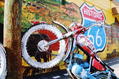 Close-up of bicycle sign against graffiti wall