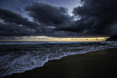 Sunset at the beach with heavy clouds