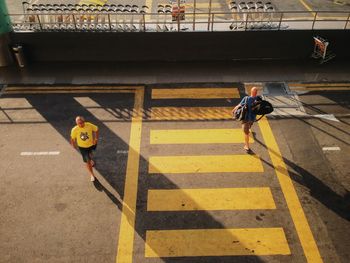 High angle view of men crossing road