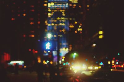 Defocused image of illuminated city at night