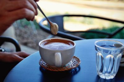 Midsection of coffee cup on table