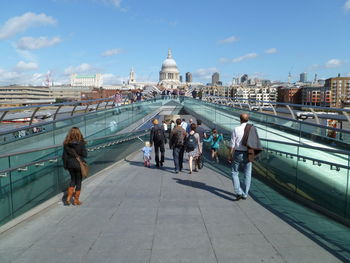 People on london millennium footbridge against st paul cathedral