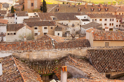 Detail to the red tiled roofs of old house of traditional spanish architecture, chinchon, spain