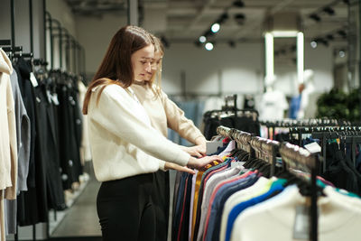 Portrait of young woman standing in store