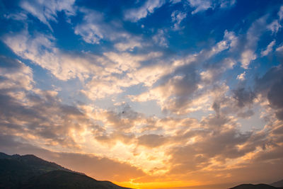 Low angle view of dramatic sky during sunset