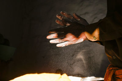 Midsection of man working on bonfire