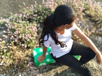 High angle view of girl sitting on land