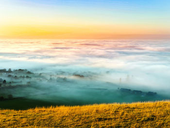 Scenic view of field against sky during sunset