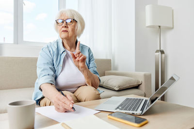 Young woman using laptop at home