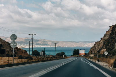 Empty road against sky beach ocean mountain view