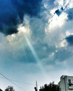 Low angle view of building against cloudy sky