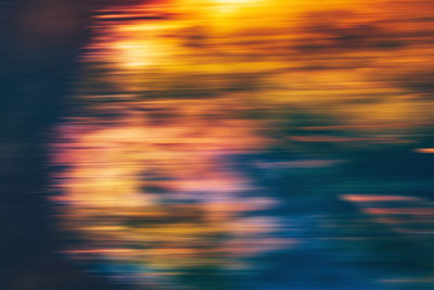 Blurred motion of illuminated sea at sunset