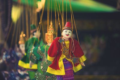 Close-up of puppets hanging at market