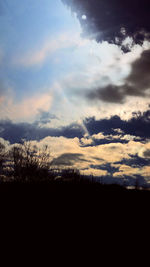 Silhouette of landscape against cloudy sky