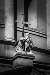 Low angle view of statue against historic building