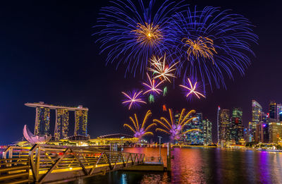 Low angle view of firework display against sky at night