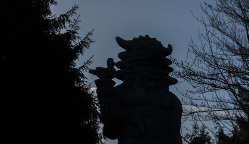 Low angle view of statue against sky