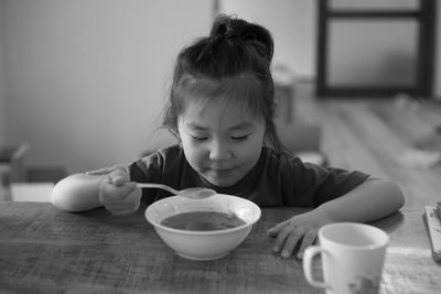 Close-up of cute boy eating food at home