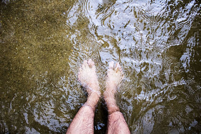 Low section of man floating in river