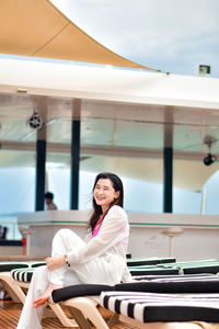 Portrait of young woman sitting in gym