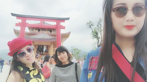 Portrait of smiling young woman standing outdoors