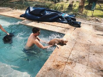 High angle view of man with dog in water
