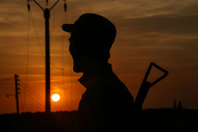 Silhouette man against sky during sunset