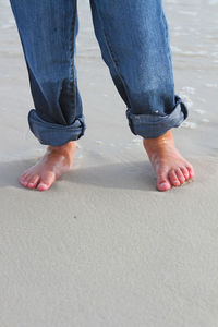 Low section of woman standing on ground