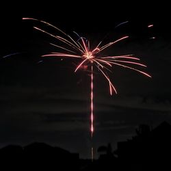 Low angle view of firework display at night