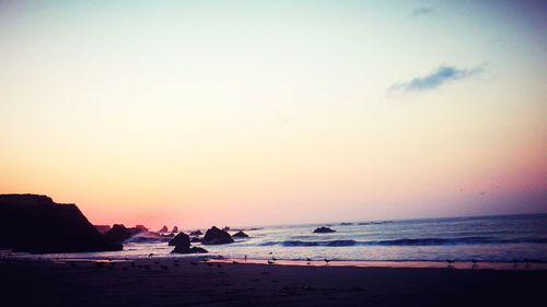 Scenic view of beach against sky during sunset