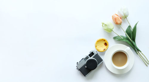 Directly above shot of breakfast on table against white background