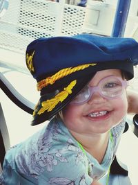 Portrait of smiling baby boy wearing cap and eyeglasses