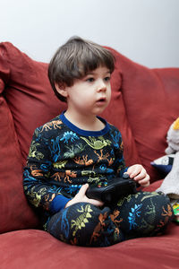Young woman sitting on sofa at home