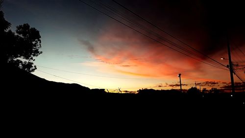 Silhouette landscape against sky during sunset