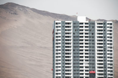 Low angle view of building against mountain range