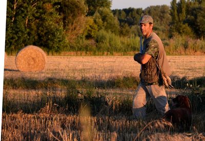 Hunter with dog on field